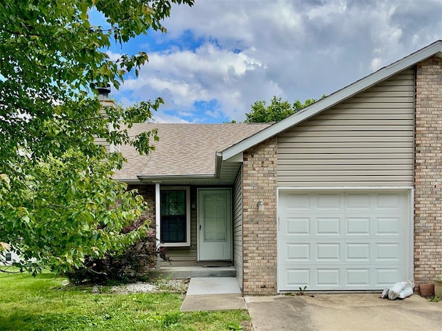 21 Fox Meadow Ln Unit A, Glen Carbon, IL 62034 - view of front of house with a chimney, an attached garage, brick siding, roof with shingles, and driveway