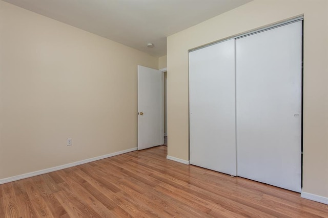 505 Stephanie Ln, Manchester, MO 63011 - unfurnished bedroom with light wood-type flooring, baseboards, and a closet