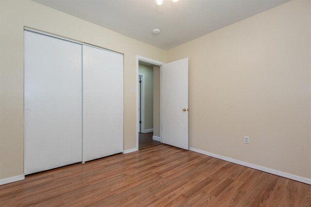 505 Stephanie Ln, Manchester, MO 63011 - unfurnished bedroom featuring light wood-style floors, baseboards, and a closet
