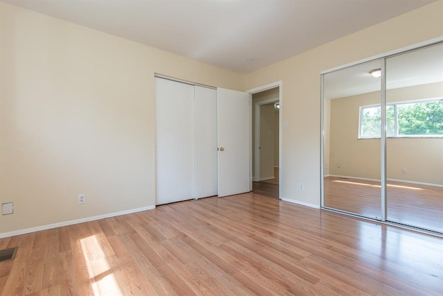 505 Stephanie Ln, Manchester, MO 63011 - unfurnished bedroom with two closets, light wood-type flooring, and baseboards