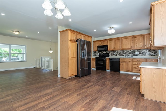 505 Stephanie Ln, Manchester, MO 63011 - kitchen with black appliances, light countertops, tasteful backsplash, a chandelier, and dark wood finished floors