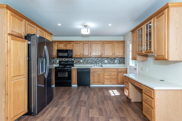 505 Stephanie Ln, Manchester, MO 63011 - kitchen featuring black appliances, light countertops, a sink, dark wood finished floors, and backsplash