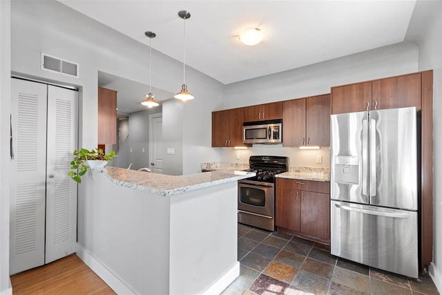 603 Westgate Ave Unit 603E, Saint Louis, MO 63130 - kitchen with stainless steel appliances, a peninsula, hanging light fixtures, light stone counters, and baseboards