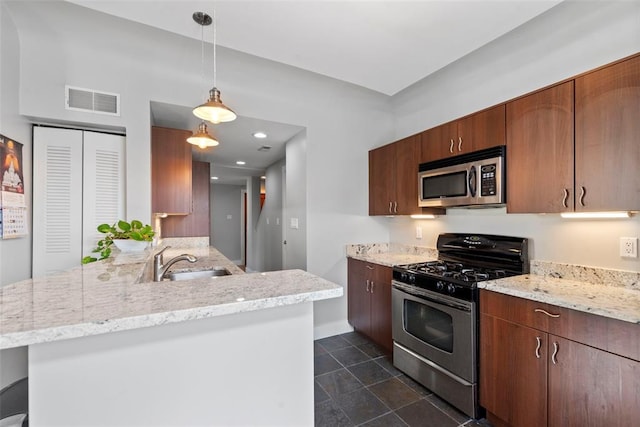 603 Westgate Ave Unit 603E, Saint Louis, MO 63130 - kitchen featuring stainless steel appliances, a sink, a peninsula, baseboards, and light stone counters