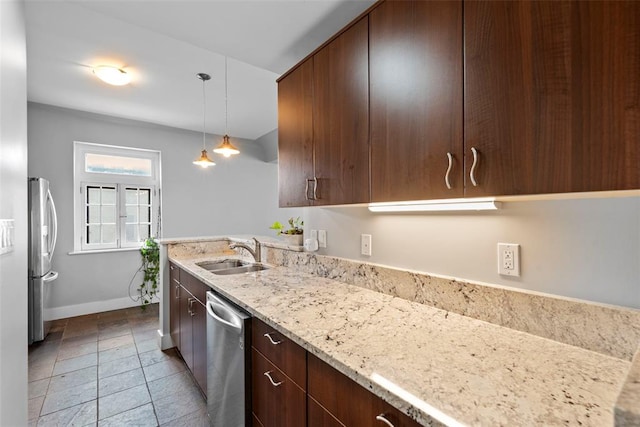 603 Westgate Ave Unit 603E, Saint Louis, MO 63130 - kitchen with stainless steel appliances, a sink, baseboards, light stone countertops, and dark brown cabinets