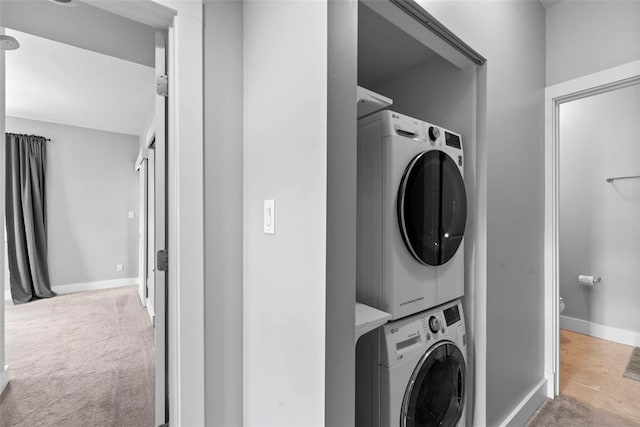 603 Westgate Ave Unit 603E, Saint Louis, MO 63130 - laundry area featuring stacked washer / drying machine, baseboards, and carpet floors