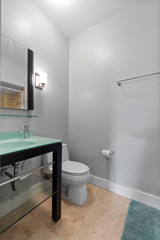 603 Westgate Ave Unit 603E, Saint Louis, MO 63130 - bathroom with a sink, toilet, baseboards, and tile patterned flooring