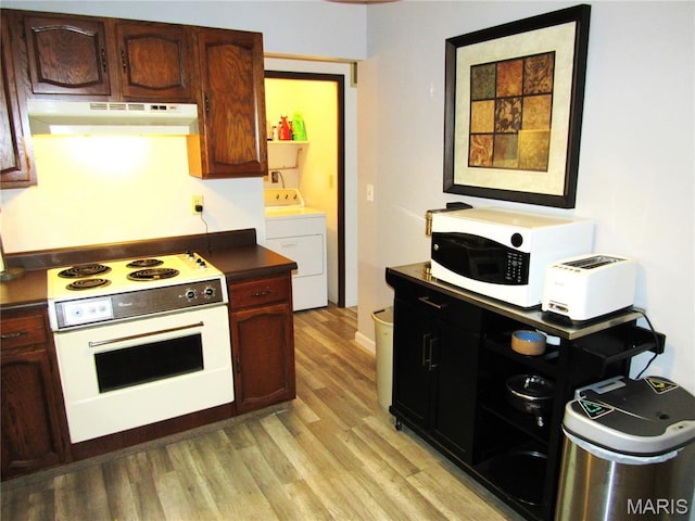 1826 Muny Vista Ct Unit B, Alton, IL 62002 - kitchen with electric stove, under cabinet range hood, washer / clothes dryer, light wood-style floors, and white microwave