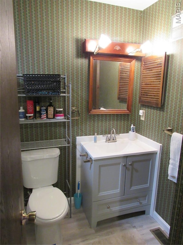 1826 Muny Vista Ct Unit B, Alton, IL 62002 - bathroom with wallpapered walls, vanity, toilet, wood finished floors, and baseboards