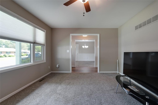 204 Chestnut Dr, Saint Charles, MO 63301 - unfurnished living room featuring carpet, a ceiling fan, a chandelier, and baseboards
