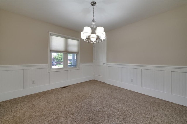 204 Chestnut Dr, Saint Charles, MO 63301 - unfurnished room featuring carpet floors, a chandelier, and wainscoting