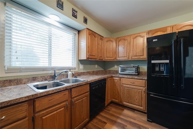 204 Chestnut Dr, Saint Charles, MO 63301 - kitchen featuring black appliances, a sink, dark wood-style flooring, and brown cabinets