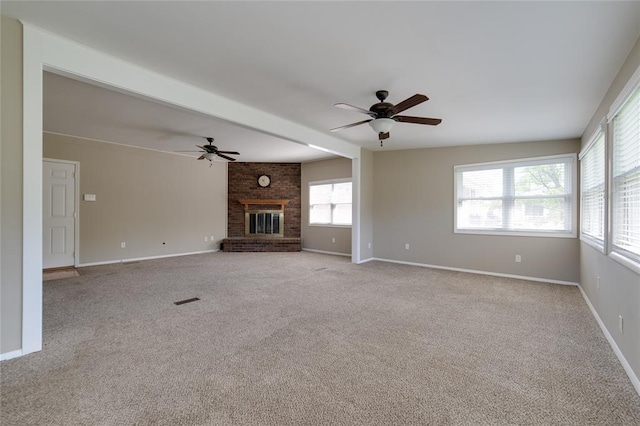 204 Chestnut Dr, Saint Charles, MO 63301 - unfurnished living room featuring a ceiling fan, carpet flooring, a fireplace, and baseboards