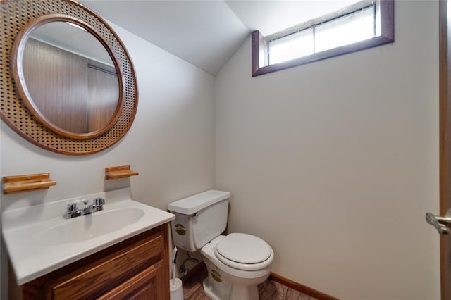 204 Chestnut Dr, Saint Charles, MO 63301 - half bath with lofted ceiling, vanity, toilet, and wood finished floors