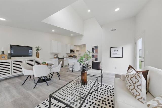 4001 Marais Temps Clair Dr, Saint Charles, MO 63304 - living area featuring light wood-style floors, high vaulted ceiling, recessed lighting, and baseboards