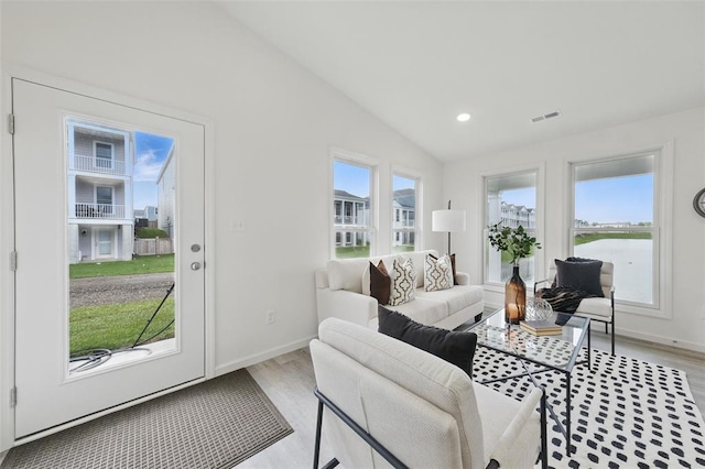4001 Marais Temps Clair Dr, Saint Charles, MO 63304 - living room featuring lofted ceiling, light wood finished floors, baseboards, a water view, and recessed lighting