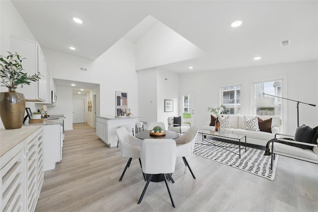 4001 Marais Temps Clair Dr, Saint Charles, MO 63304 - dining space featuring light wood finished floors, recessed lighting, and a towering ceiling