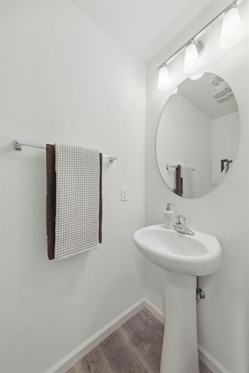 4001 Marais Temps Clair Dr, Saint Charles, MO 63304 - bathroom featuring baseboards, wood finished floors, and a sink