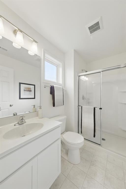 4001 Marais Temps Clair Dr, Saint Charles, MO 63304 - bathroom with a shower stall, vanity, toilet, and tile patterned floors