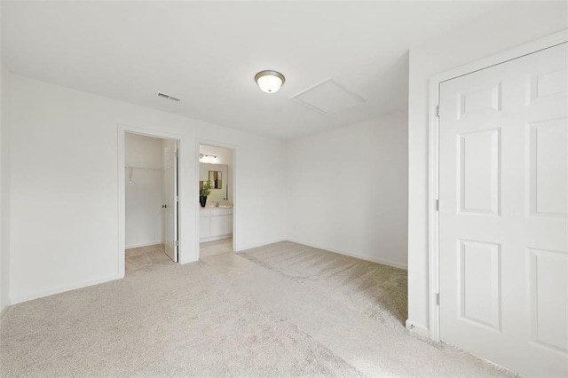 4001 Marais Temps Clair Dr, Saint Charles, MO 63304 - unfurnished bedroom featuring light colored carpet, a walk in closet, attic access, a closet, and baseboards