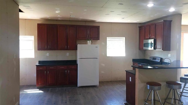2357 Pine St, Centerville, MO 63633 - kitchen with stainless steel appliances, wood finished floors, healthy amount of natural light, and dark countertops