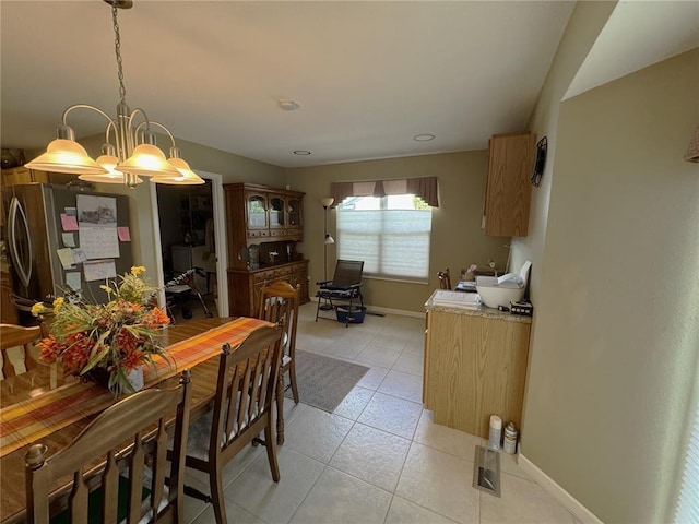 113 Fairway Dr, Maryville, IL 62062 - dining area with light tile patterned floors, baseboards, and a chandelier