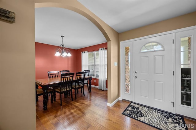 8525 Sagamore Dr, Cedar Hill, MO 63016 - entrance foyer featuring arched walkways, light wood-style flooring, and a chandelier