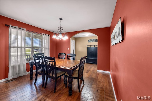 8525 Sagamore Dr, Cedar Hill, MO 63016 - dining room with arched walkways, a chandelier, and wood-type flooring
