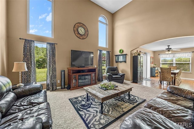 8525 Sagamore Dr, Cedar Hill, MO 63016 - carpeted living room featuring a towering ceiling, ceiling fan, and arched walkways