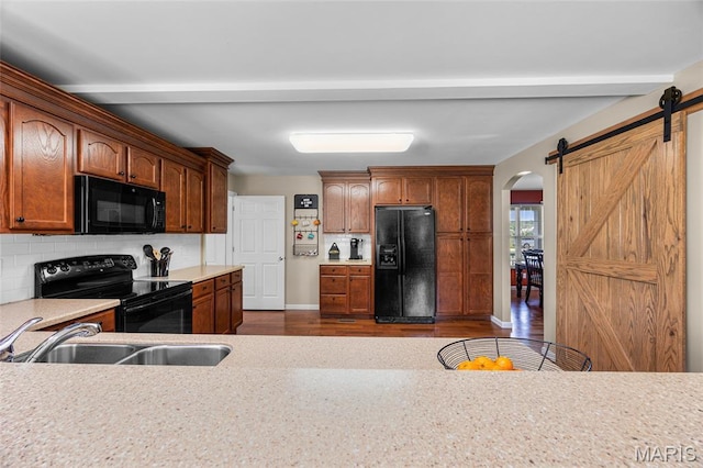 8525 Sagamore Dr, Cedar Hill, MO 63016 - kitchen with black appliances, decorative backsplash, dark wood finished floors, light countertops, and arched walkways