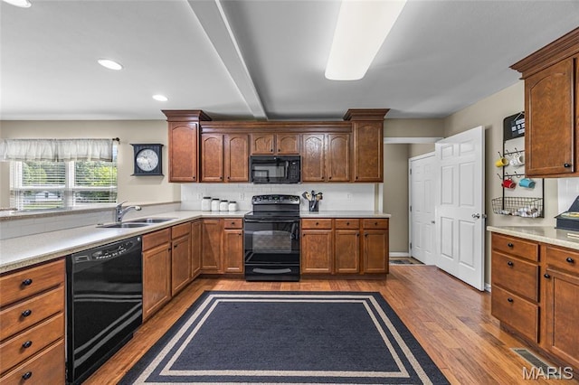 8525 Sagamore Dr, Cedar Hill, MO 63016 - kitchen featuring black appliances, dark wood-type flooring, light countertops, decorative backsplash, and recessed lighting