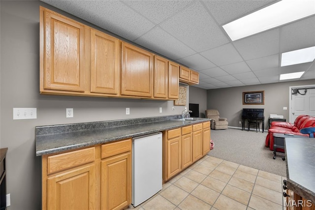 8525 Sagamore Dr, Cedar Hill, MO 63016 - kitchen featuring dark countertops, light colored carpet, a paneled ceiling, open floor plan, and light tile patterned floors