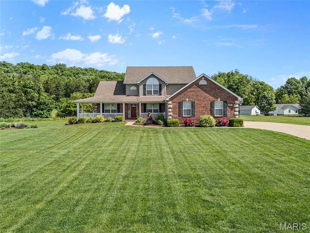 8525 Sagamore Dr, Cedar Hill, MO 63016 - view of front of property featuring covered porch, a front lawn, concrete driveway, and brick siding