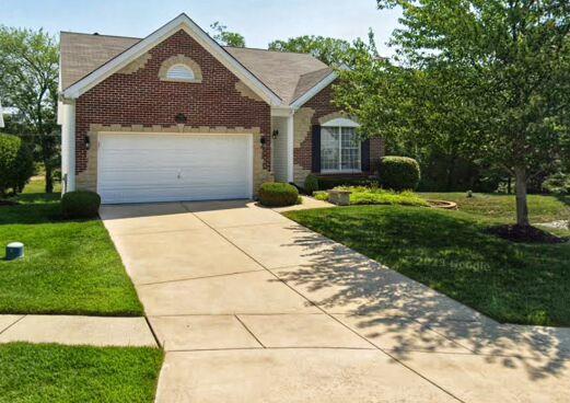 734 River Glen Dr, Ofallon, MO 63368 - view of front of home featuring brick siding, concrete driveway, a front yard, and a garage