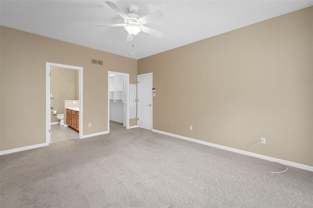 734 River Glen Dr, Ofallon, MO 63368 - unfurnished bedroom featuring light colored carpet, baseboards, a walk in closet, ensuite bathroom, and a closet