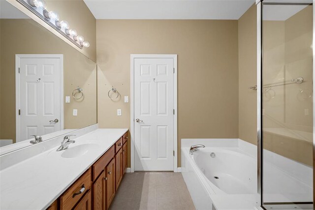 734 River Glen Dr, Ofallon, MO 63368 - bathroom featuring vanity, tile patterned flooring, a bath, and baseboards