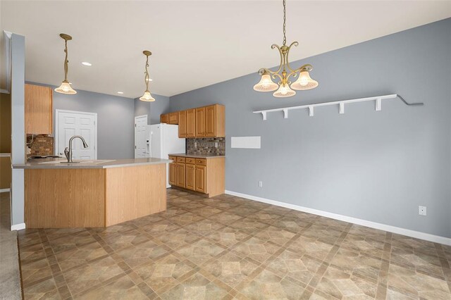 734 River Glen Dr, Ofallon, MO 63368 - kitchen featuring a sink, tasteful backsplash, a peninsula, hanging light fixtures, and recessed lighting