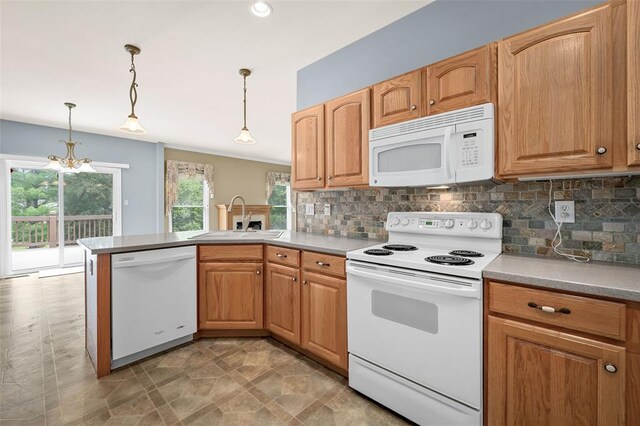 734 River Glen Dr, Ofallon, MO 63368 - kitchen featuring white appliances, a sink, a peninsula, backsplash, and recessed lighting