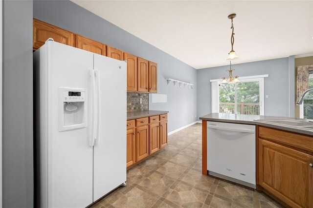 734 River Glen Dr, Ofallon, MO 63368 - kitchen with white appliances, a sink, pendant lighting, decorative backsplash, and brown cabinetry