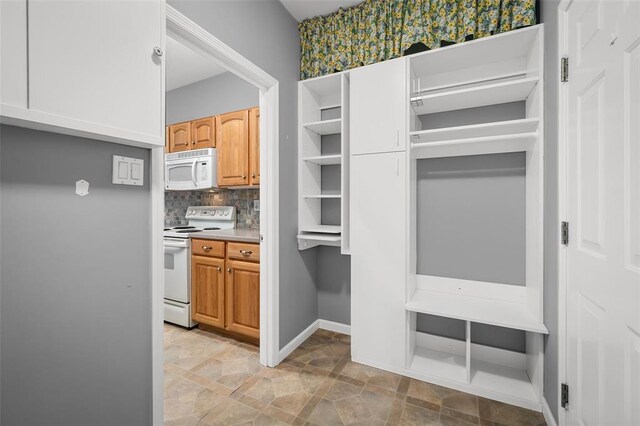 734 River Glen Dr, Ofallon, MO 63368 - kitchen featuring white appliances, decorative backsplash, open shelves, light countertops, and baseboards