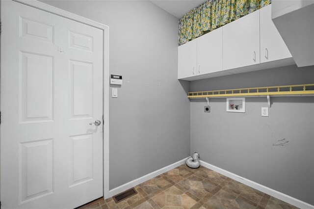 734 River Glen Dr, Ofallon, MO 63368 - laundry area with hookup for an electric dryer, baseboards, washer hookup, cabinet space, and dark stone finish flooring