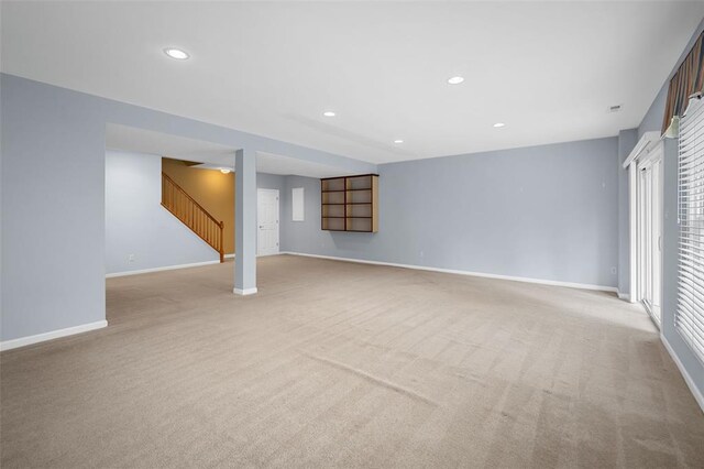 734 River Glen Dr, Ofallon, MO 63368 - below grade area featuring light colored carpet, baseboards, recessed lighting, and stairway
