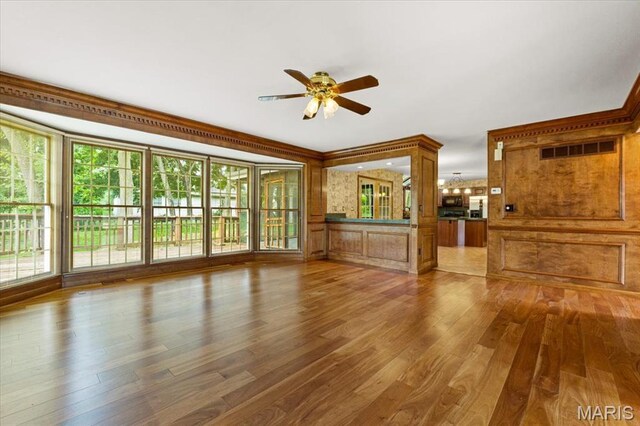 767 Carman Meadows Dr S, Manchester, MO 63021 - unfurnished living room featuring ceiling fan, wood finished floors, and healthy amount of natural light