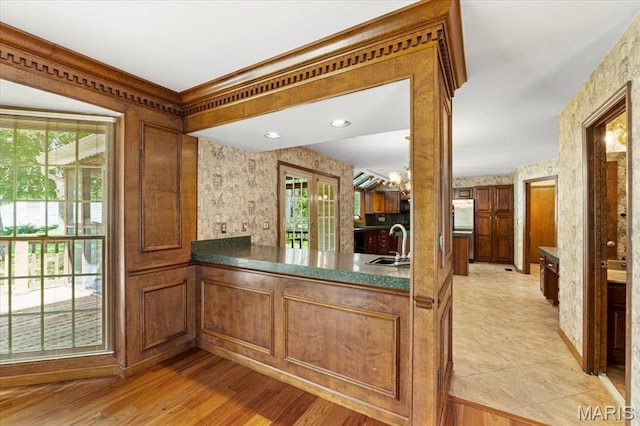 767 Carman Meadows Dr S, Manchester, MO 63021 - kitchen with wallpapered walls and brown cabinets