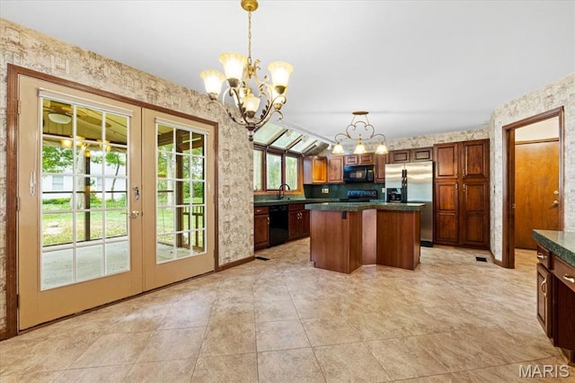 767 Carman Meadows Dr S, Manchester, MO 63021 - kitchen with black appliances, wallpapered walls, a chandelier, french doors, and dark countertops