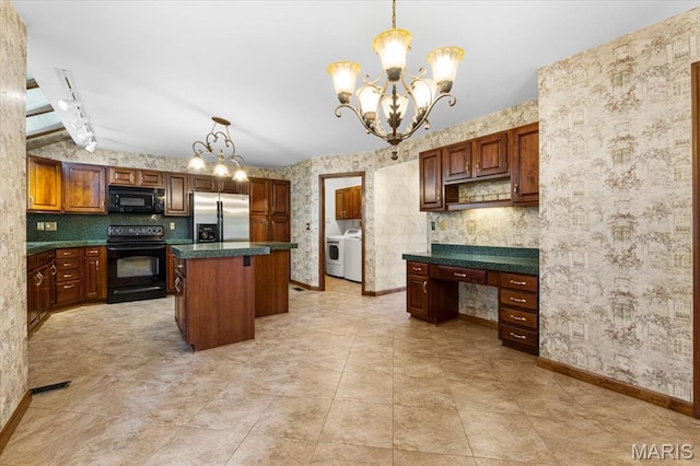 767 Carman Meadows Dr S, Manchester, MO 63021 - kitchen with black appliances, washer / dryer, wallpapered walls, a chandelier, and dark countertops