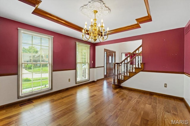 767 Carman Meadows Dr S, Manchester, MO 63021 - foyer entrance featuring a raised ceiling, a chandelier, wood finished floors, and ornamental molding