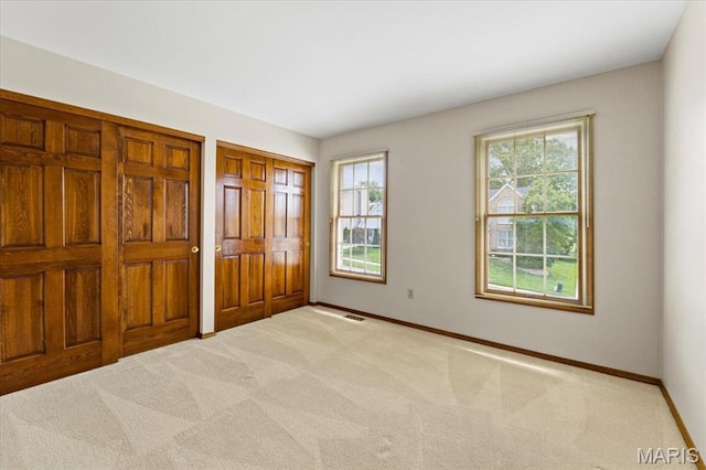 767 Carman Meadows Dr S, Manchester, MO 63021 - unfurnished bedroom featuring light carpet and two closets