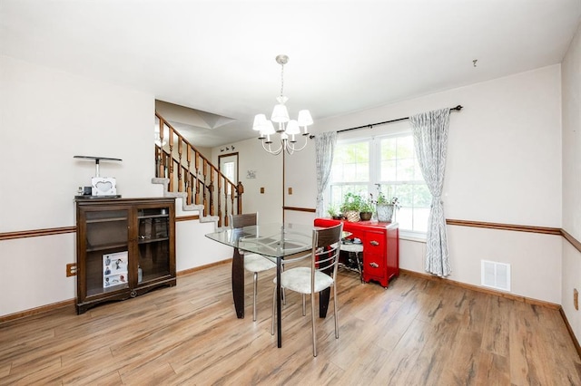 14 Shallowbrook Dr, Ofallon, IL 62269 - dining room featuring light wood-type flooring, a chandelier, stairs, and baseboards