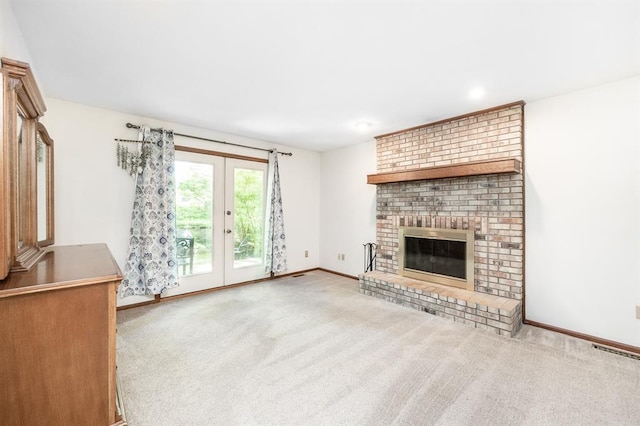 14 Shallowbrook Dr, Ofallon, IL 62269 - unfurnished living room featuring french doors, carpet floors, a fireplace, baseboards, and recessed lighting